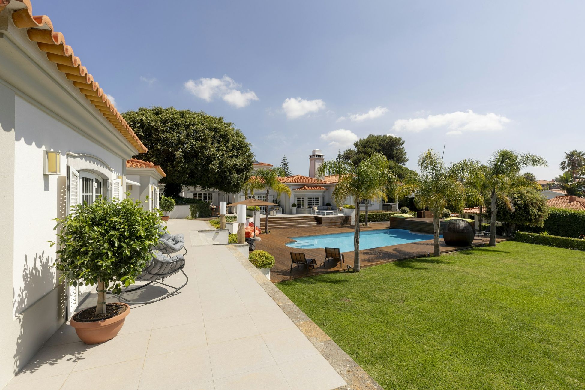 Swimming pool, palm gardens and terrace at Cascais Vacation villa in Cascais, Portugal