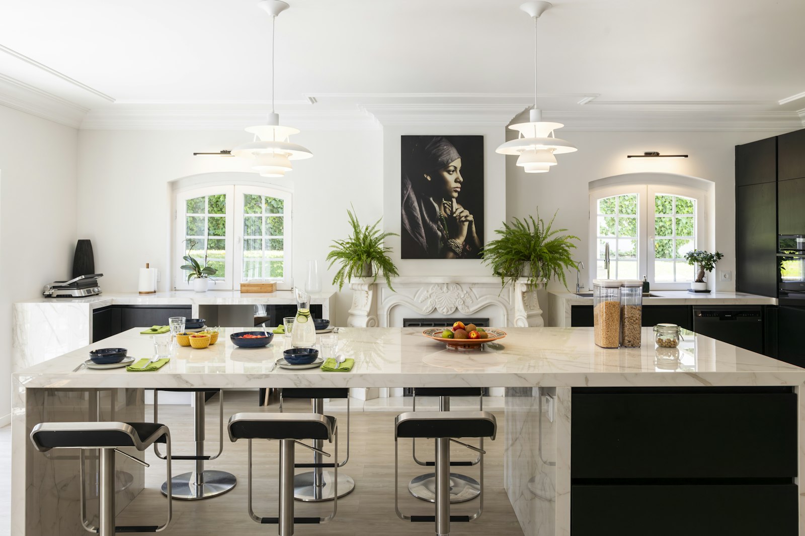 Marble kitchen islands, bar stools and fireplace at Cascais Vacation villa in Cascais, Portugal