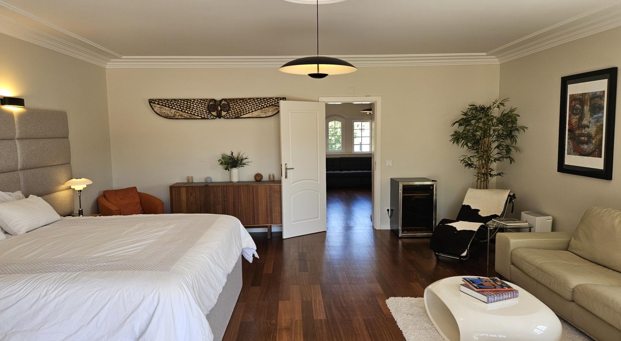 King bed, leather sofa and arched window in the upstairs master at Cascais Vacation villa, Cascais, Portugal